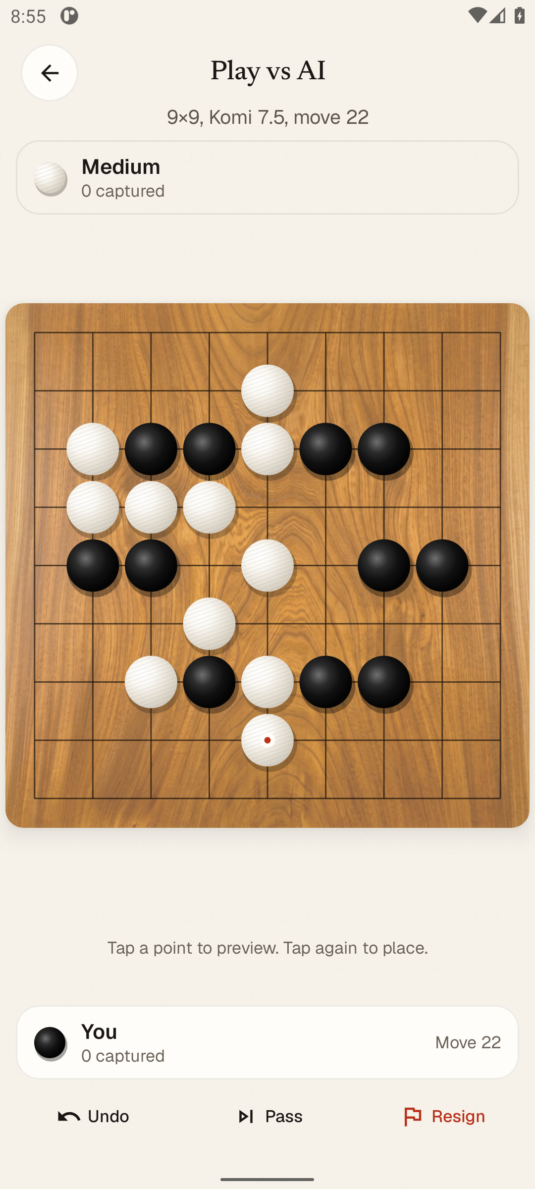 Android screenshot: Play vs AI on a 9x9 goban, Medium, mid-game around move 22